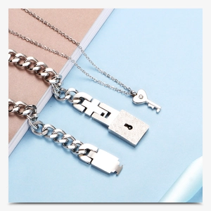 Detail of silver couple jewelry set with link lock bracelet and key pendant necklace