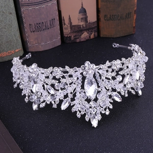 Detail of silver bridal crown with crystals and leaf rhinestones on vintage background