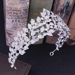 Elegant silver bridal leaf crown with sparkling rhinestones on vintage books background