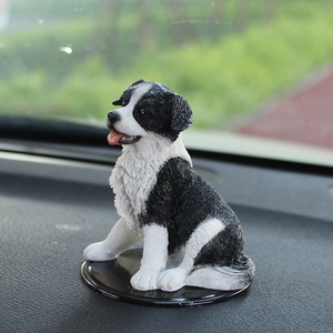 Realistic Border Collie car ornament in black and white resin sitting on dashboard