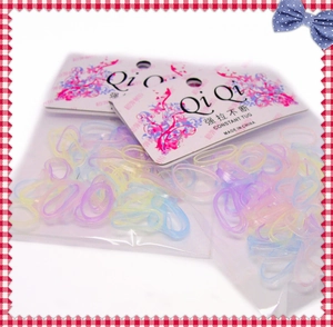 Macro shot of assorted macaron colored elastic hair ties in clear poly bag packaging