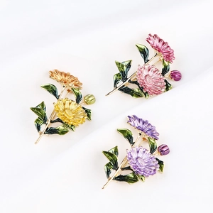 Detailed close-up of yellow, pink and purple enamel floral brooches with gold stems