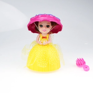 Detail of princess doll with yellow polka dot dress and a pink heart comb toy accessory