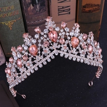 Detail of luxury bridal tiara with pink crystals and rose gold metal on vintage books