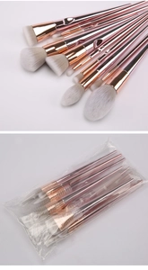 Macro view of 10-piece rose gold makeup brushes with grey gradient synthetic bristles