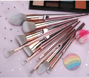 Set of 10 rose gold makeup brushes with grey-white bristles on pink sequin mesh