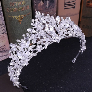 Close-up of silver bridal crown featuring leaf patterns and sparkling crystal beads