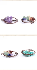 Detail of tree of life pendants with handmade copper wire and natural colorful gemstones