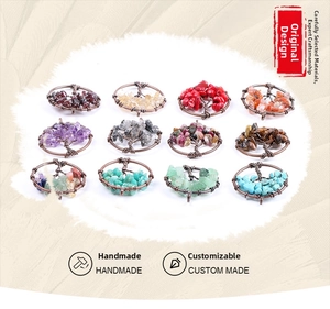 Matrix display of twelve handmade tree of life pendants in various natural crystal stones