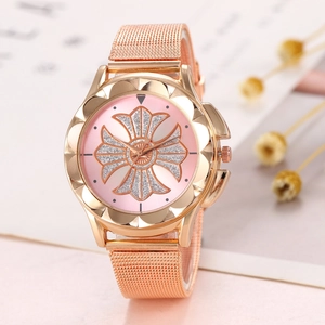 Close-up of rose gold mesh band watch with pink floral dial and glitter accents