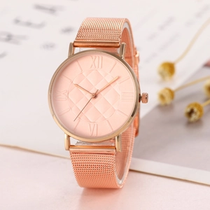 Detailed shot of rose gold watch with quilted dial pattern and Milanese mesh band