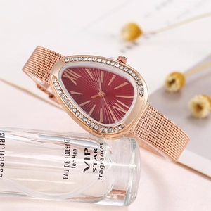 Detail of rose gold snake-shaped watch with red sunray dial and mesh strap on pink base