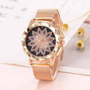 Detail of rose gold mesh watch with rhinestone floral dial on minimalist background