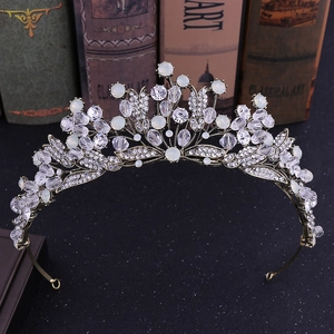 Baroque vintage rhinestone bridal crown with gold leaves and crystals on dark base