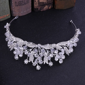Detailed view of Baroque silver crystal crown with rhinestone leaves on vintage books