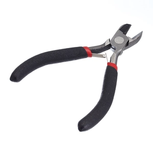 Close-up of professional diagonal pliers with red-black handle and sharp steel blade