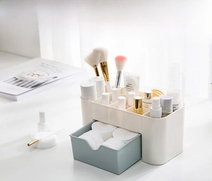 Close-up of cream white storage box with six compartments and light blue translucent drawer
