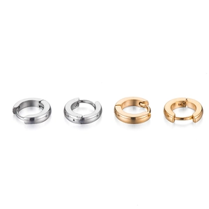 Polished gold and silver minimalist stainless steel hoop earrings set on white background