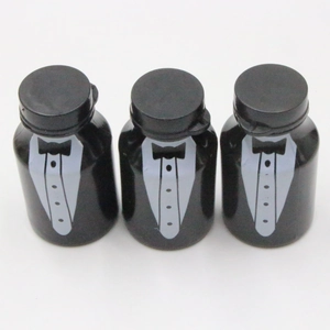 Detailed view of three black bubble bottles with white tuxedo shirt and bowtie prints