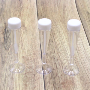Three transparent heart-shaped test tube bubble bottles with white caps for weddings