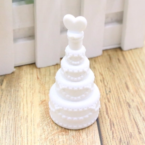 Close-up of white heart-shaped bubble wand bottle on wooden floor for wedding decor