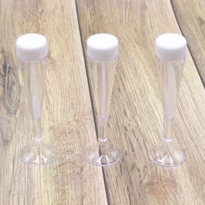 Three clear champagne glass shaped bubble wands with white screw caps for wedding decor