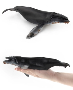 Detailed humpback whale toy model showing realistic texture and size scale held by hand