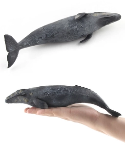 Detailed grey whale model toy showing realistic skin texture and scale in a hand