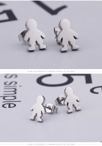 Macro view of polished silver cartoon boy silhouette stud earrings with butterfly backs