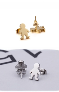 Detailed view of polished character-shaped stud earrings in gold and silver finishes