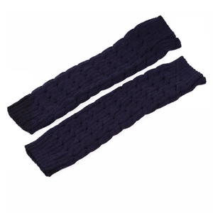 Detail of navy blue knit leg warmers showing the classic cable stitch texture