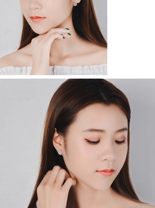 Close-up of silver windmill zircon stud earrings worn by a model in a dual-split view