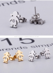 Macro shot of minimalist girl-shaped stud earrings with sparkling round cubic zirconia
