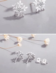 Detailed view of S925 sterling silver snowflake stud earrings with zirconia stones