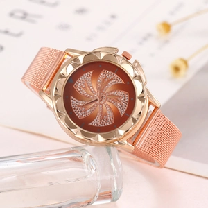 Detail of rose gold fashion watch featuring a rotating rhinestone windmill dial design