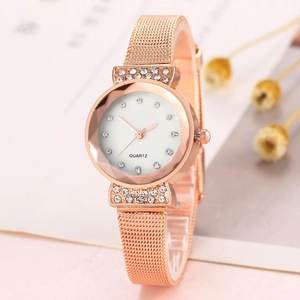 Close-up of rose gold mesh strap watch with sparkling rhinestone case and quartz dial