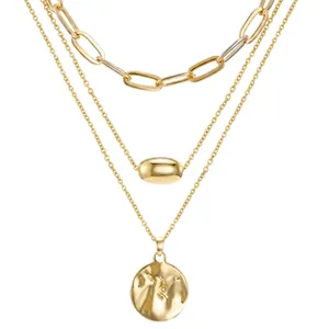 Three-layer gold necklace with paperclip chain and hammered round metal pendant