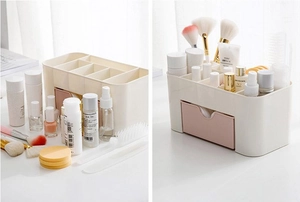 Cosmetic organizer featuring pink drawers and multiple compartments for makeup storage