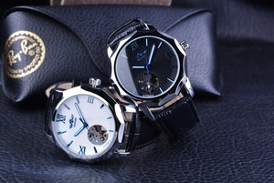 Close-up of black and white dial skeleton automatic watches with Roman numerals