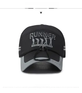 Detail of black sports cap featuring grey RUNNER embroidery and adjustable wind cord