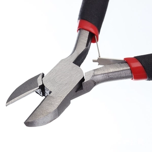 Close-up of wire cutter head showing sharp blade and built-in leaf spring mechanism