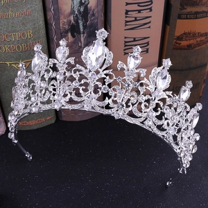 Close-up of silver bridal crown with intricate metalwork and clear marquise rhinestones