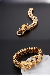 Close-up of golden dragon head bracelet with detailed scales and heavy metal chain links