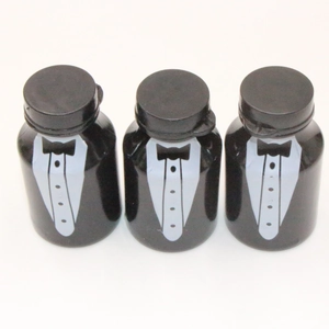 Three black bubble wands with white tuxedo patterns for wedding decorations on white background