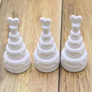 Close-up of three white heart-shaped bubble bottle wands for wedding table decorations
