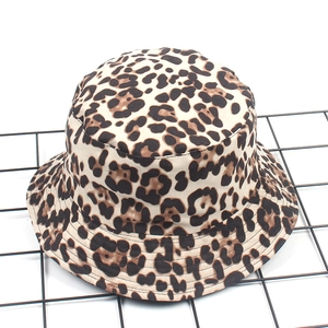 Detailed view of leopard print bucket hat texture on a black wire grid display