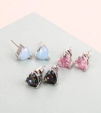 Close-up of three heart-shaped stud earrings in blue opal and colorful zircon on a stand
