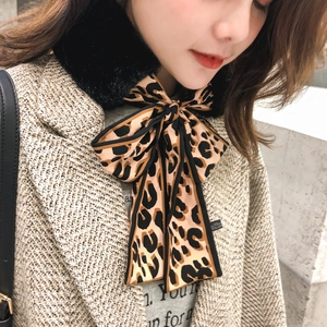 Faux rabbit fur collar with leopard print ribbon bow tie styled on a winter wool coat