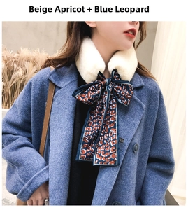 Close-up of beige faux rabbit fur collar with a blue leopard print silk ribbon scarf
