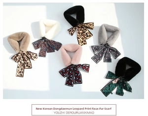 Flat lay of leopard print faux rabbit fur scarves with elegant satin ribbon bow details